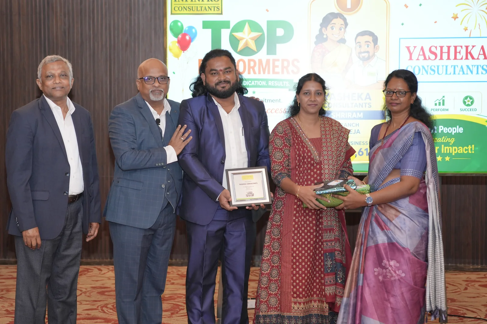 An entrepreneur receiving recognition from the INFINPRO leadership team